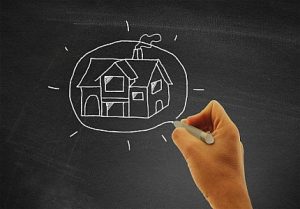 hand-drawing-a-house-on-blackboard-real-estate-and-housing-con-300x209