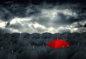 red-umbrella-mingling-with-grey-umbrellas-be-different-concept-300x205